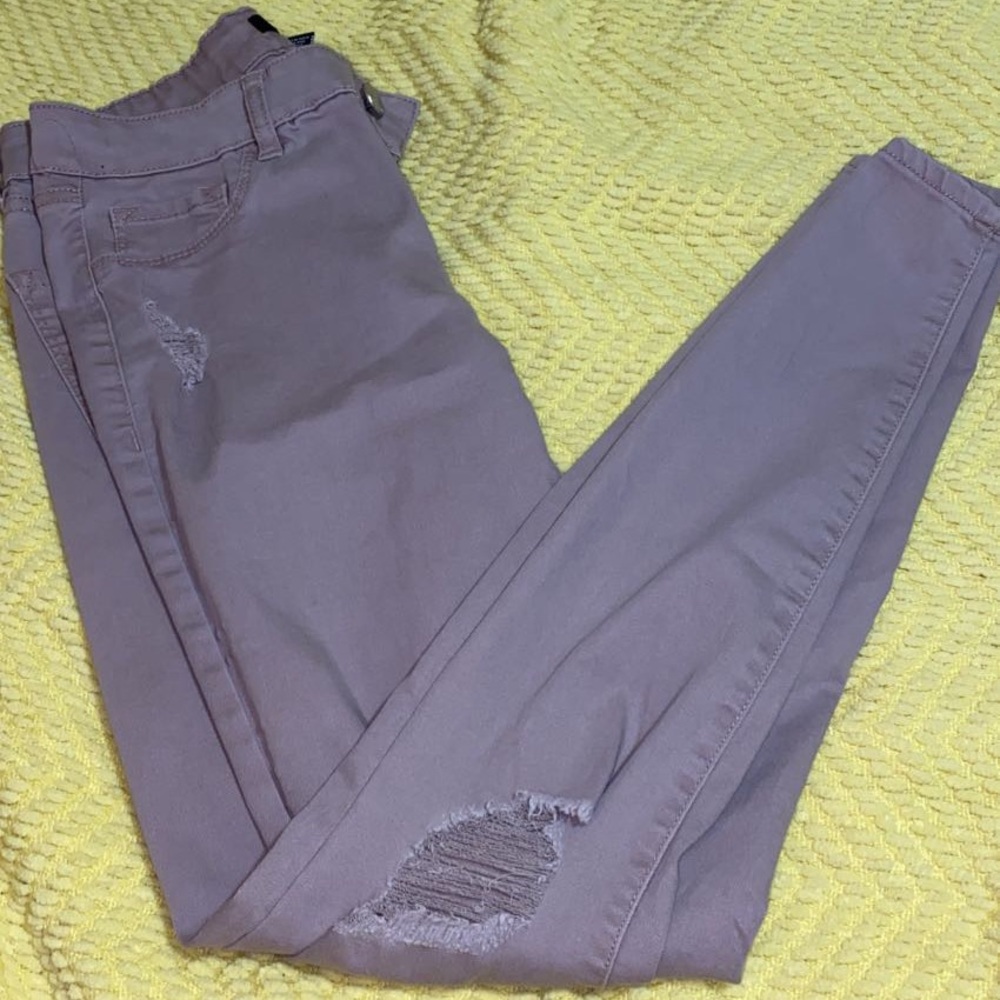 Mauve pink ripped skinny jeans.